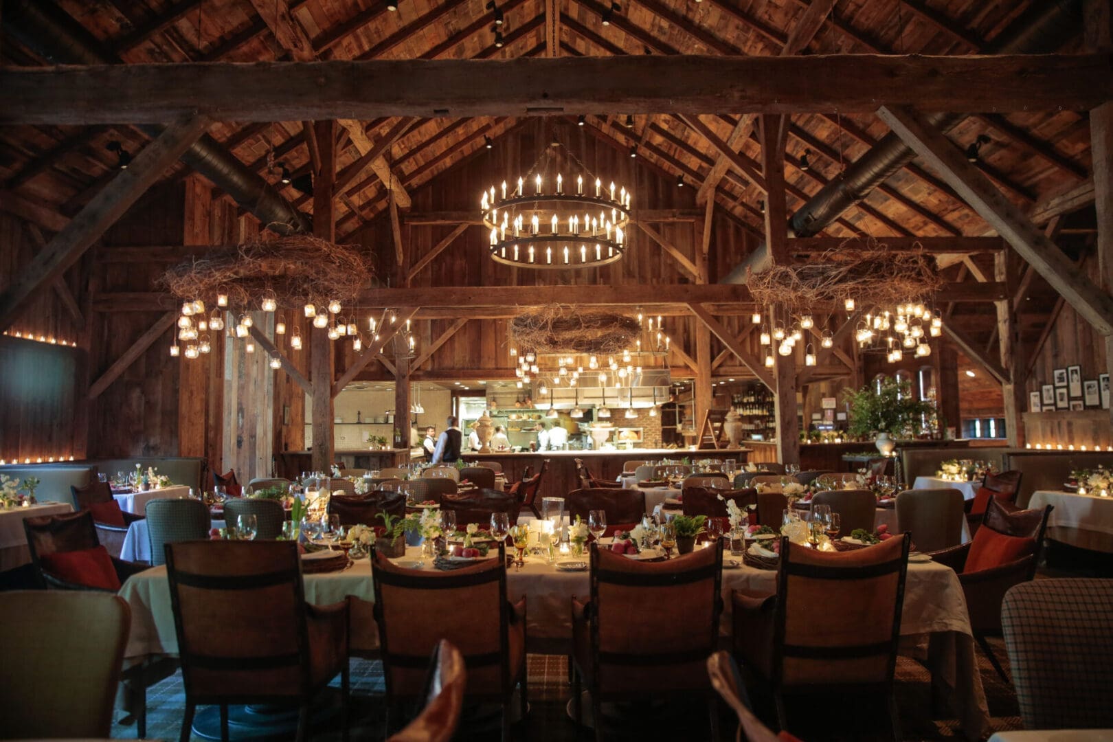 Elegant rustic dining room with warm lighting and wooden beams.