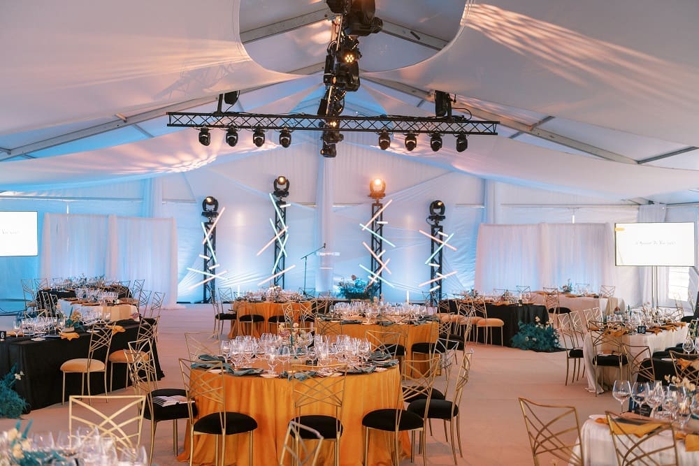 Elegant banquet hall set for a formal event with round tables and ambient lighting.
