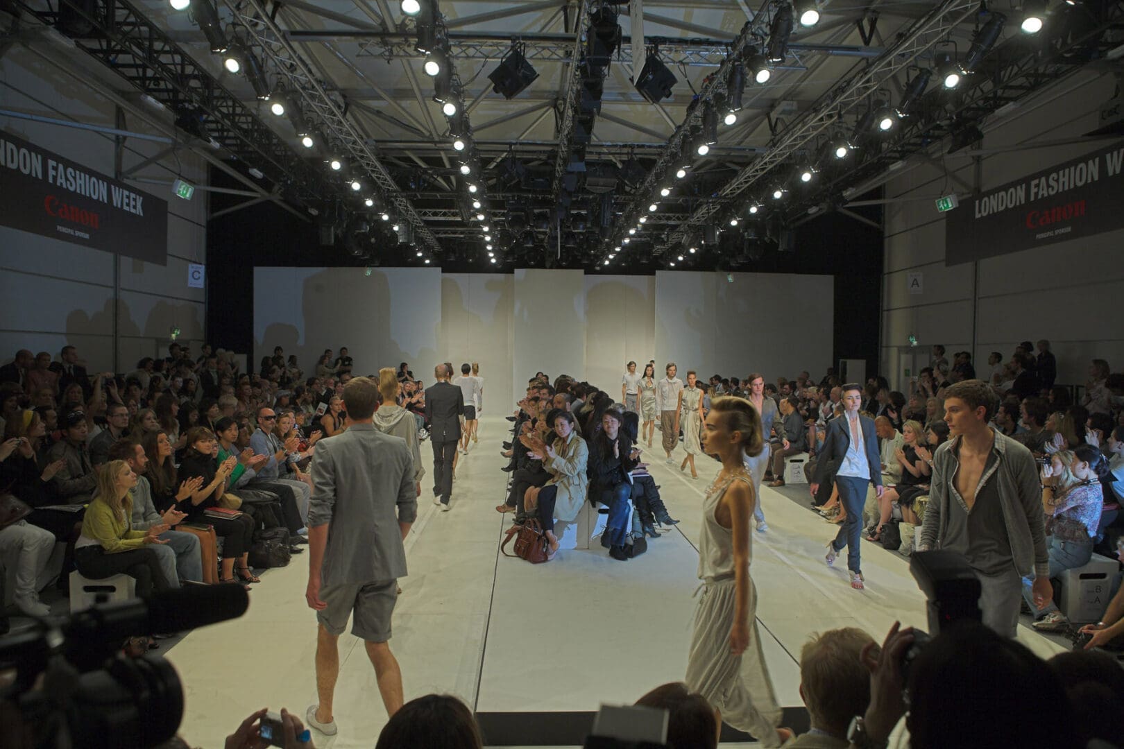 Models walking down a runway during a fashion show.