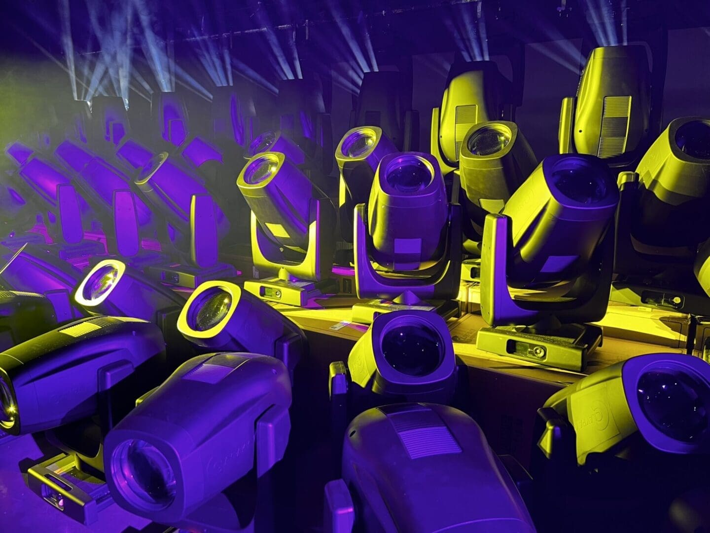 Stage lighting equipment with yellow and purple lights.
