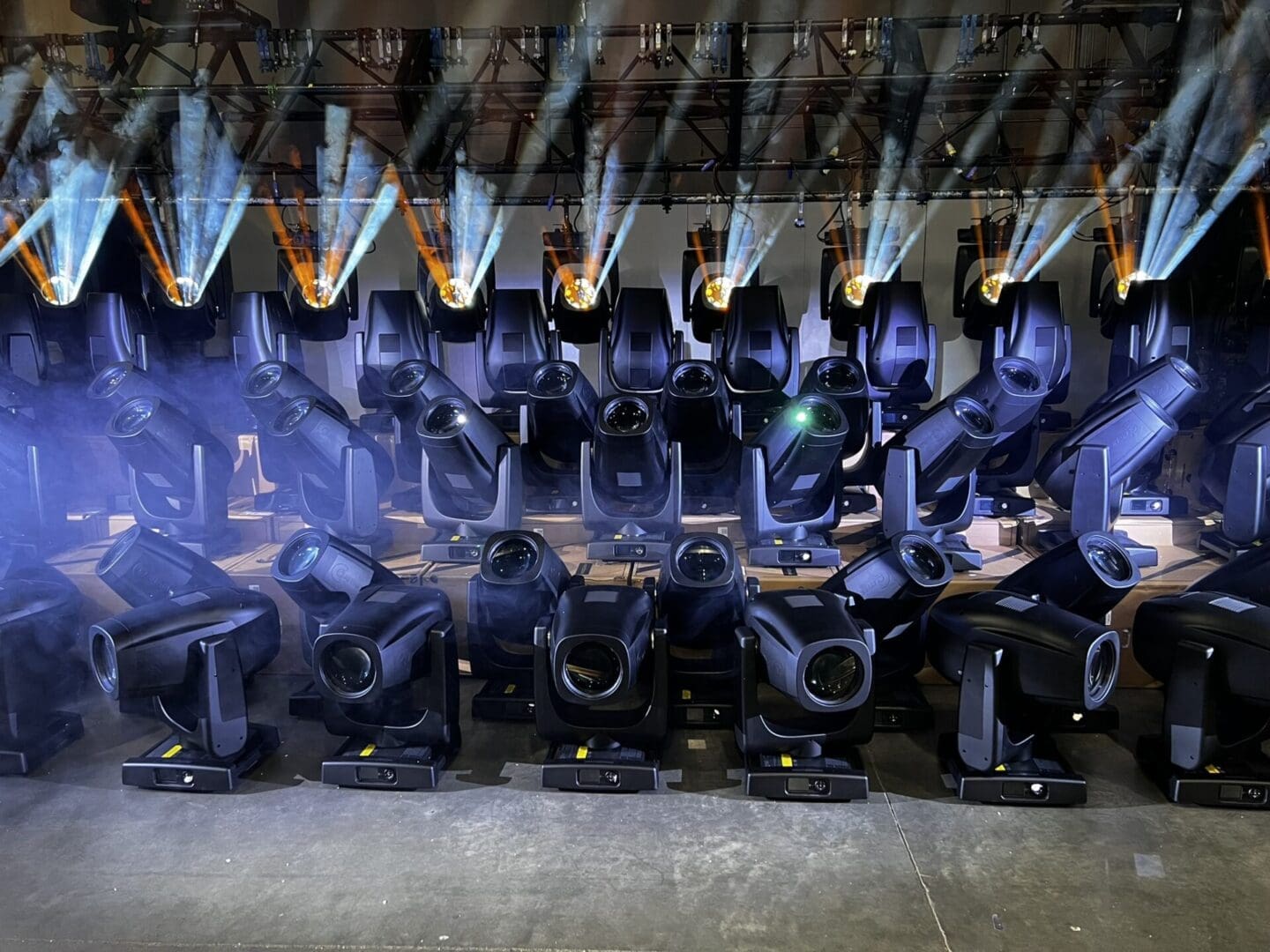 A group of people holding rifles in a dark, smoky room.