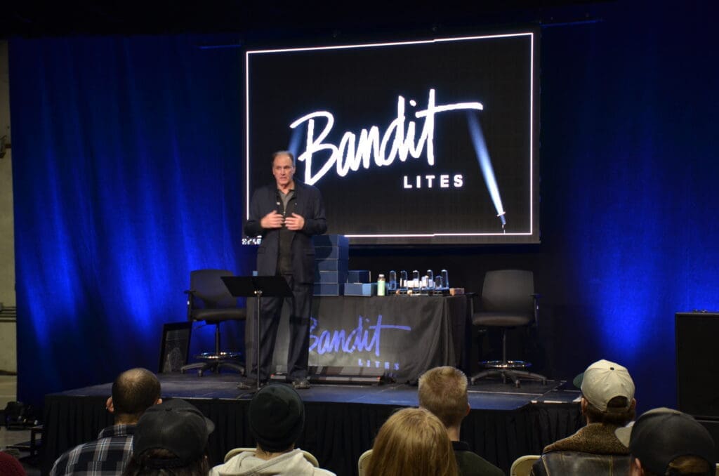 A speaker presenting at a Bandit Lites event on stage.