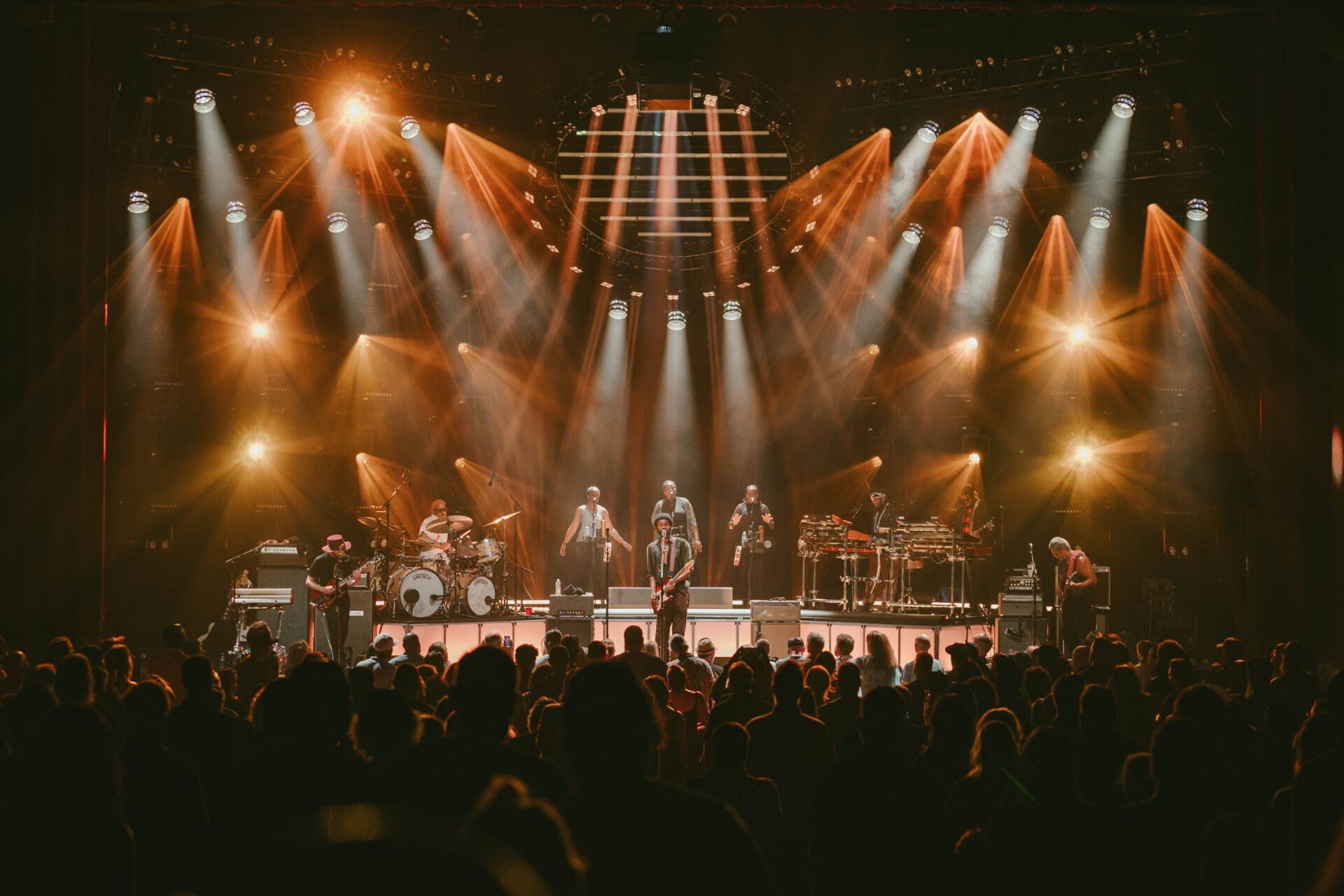A vibrant concert stage with performers and bright lights.