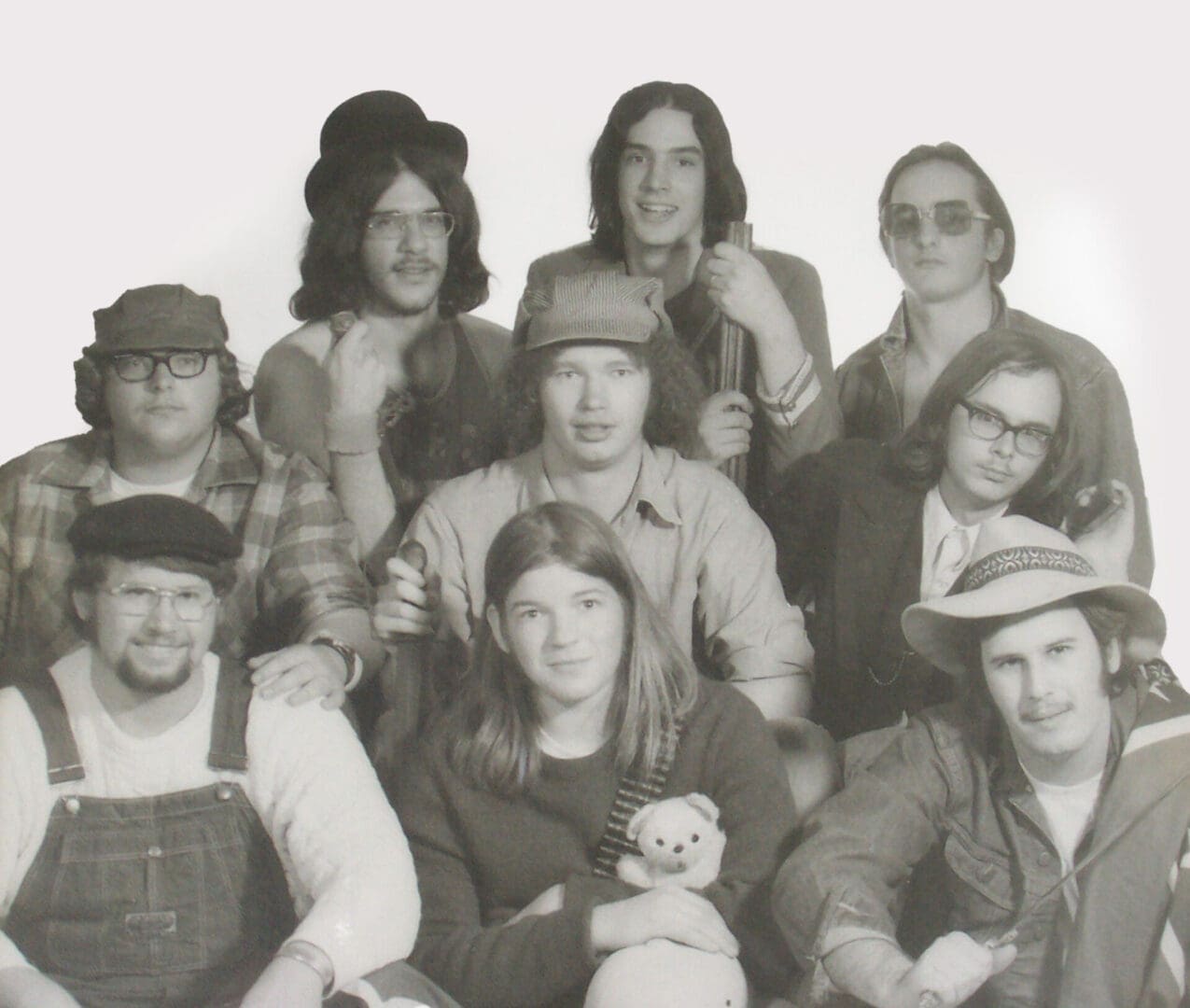 Black-and-white group photo of actors in vintage costumes.
