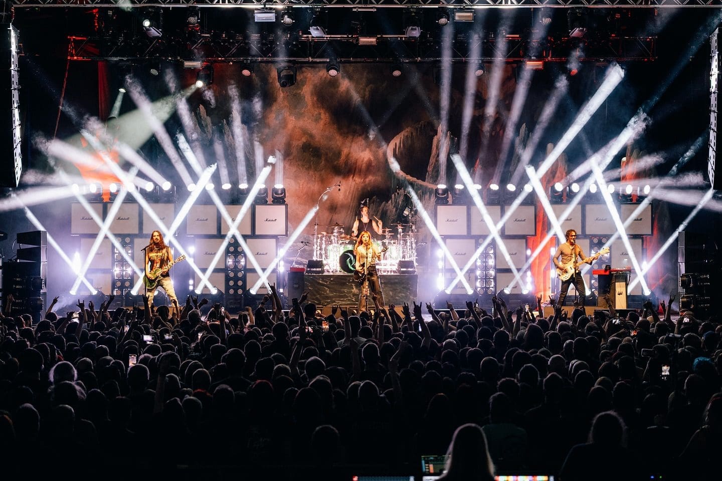 Energetic live concert with dynamic lighting and a large crowd.