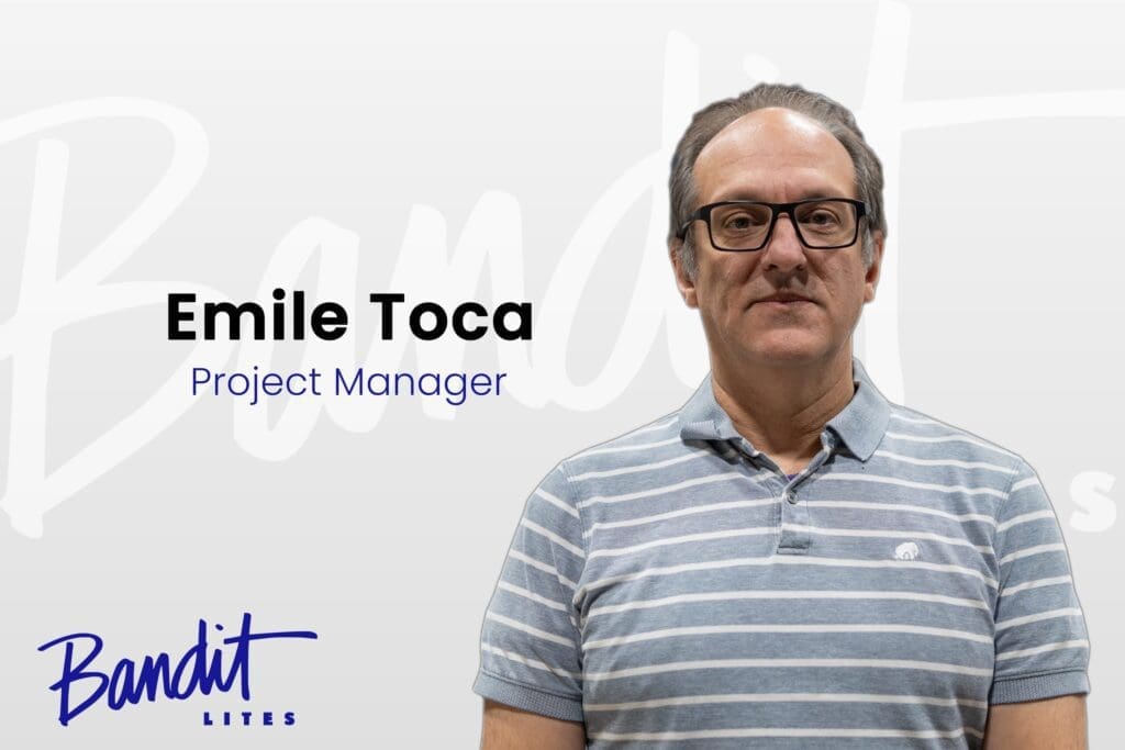 A professional man identified as Emile Toca, Project Manager, stands against a white background with a company logo.