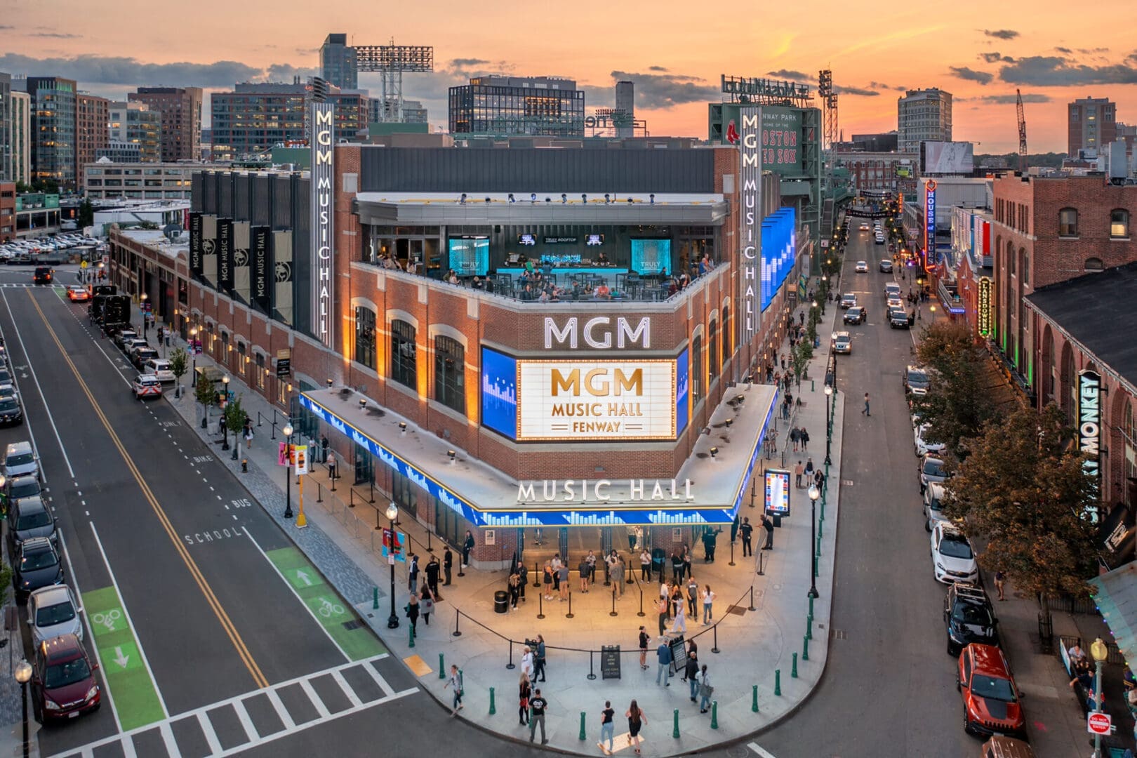 MCM store at sunset on a bustling city street corner.