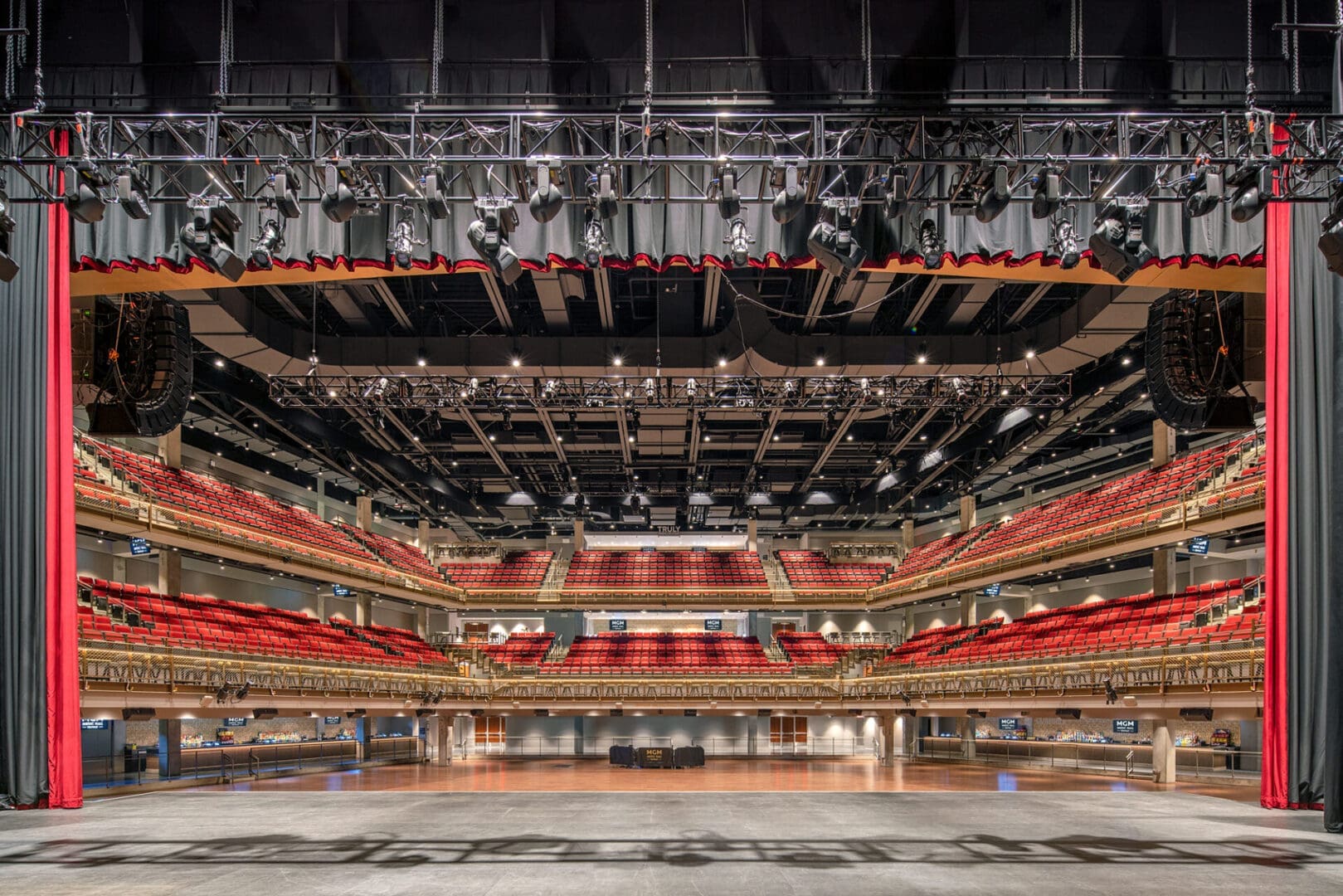 Interior view of a large, empty theater with multiple balconies and stage.