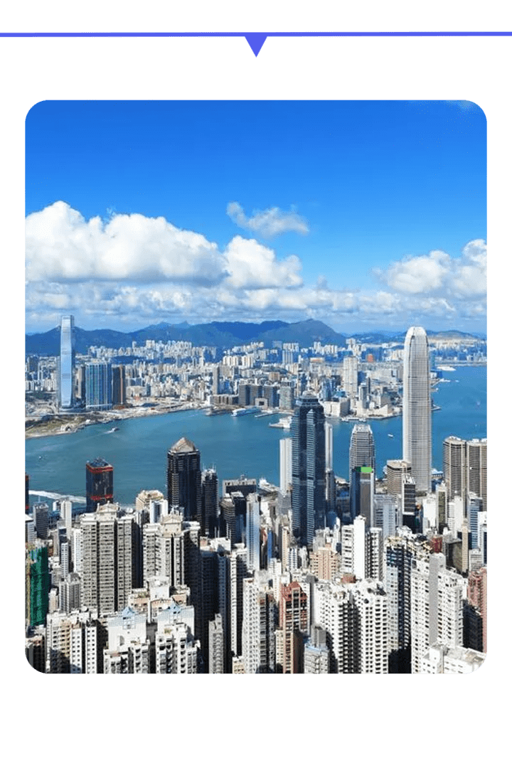City skyline with tall buildings and a clear blue sky.