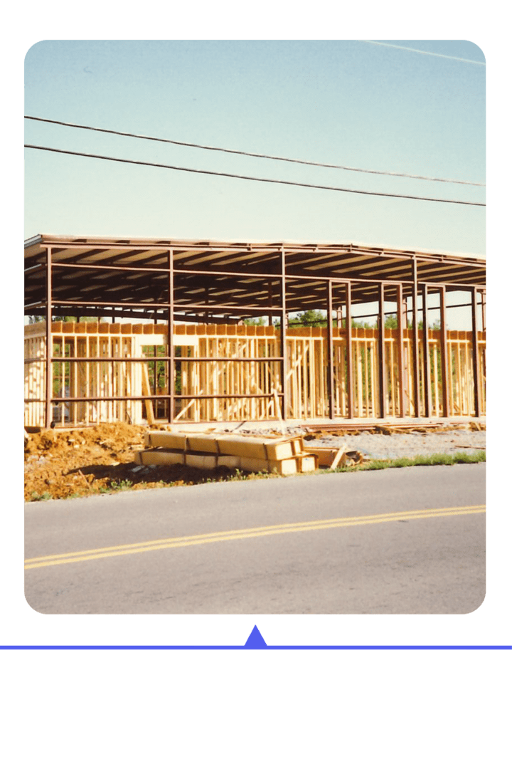 Construction site with wooden framing of a building in progress.