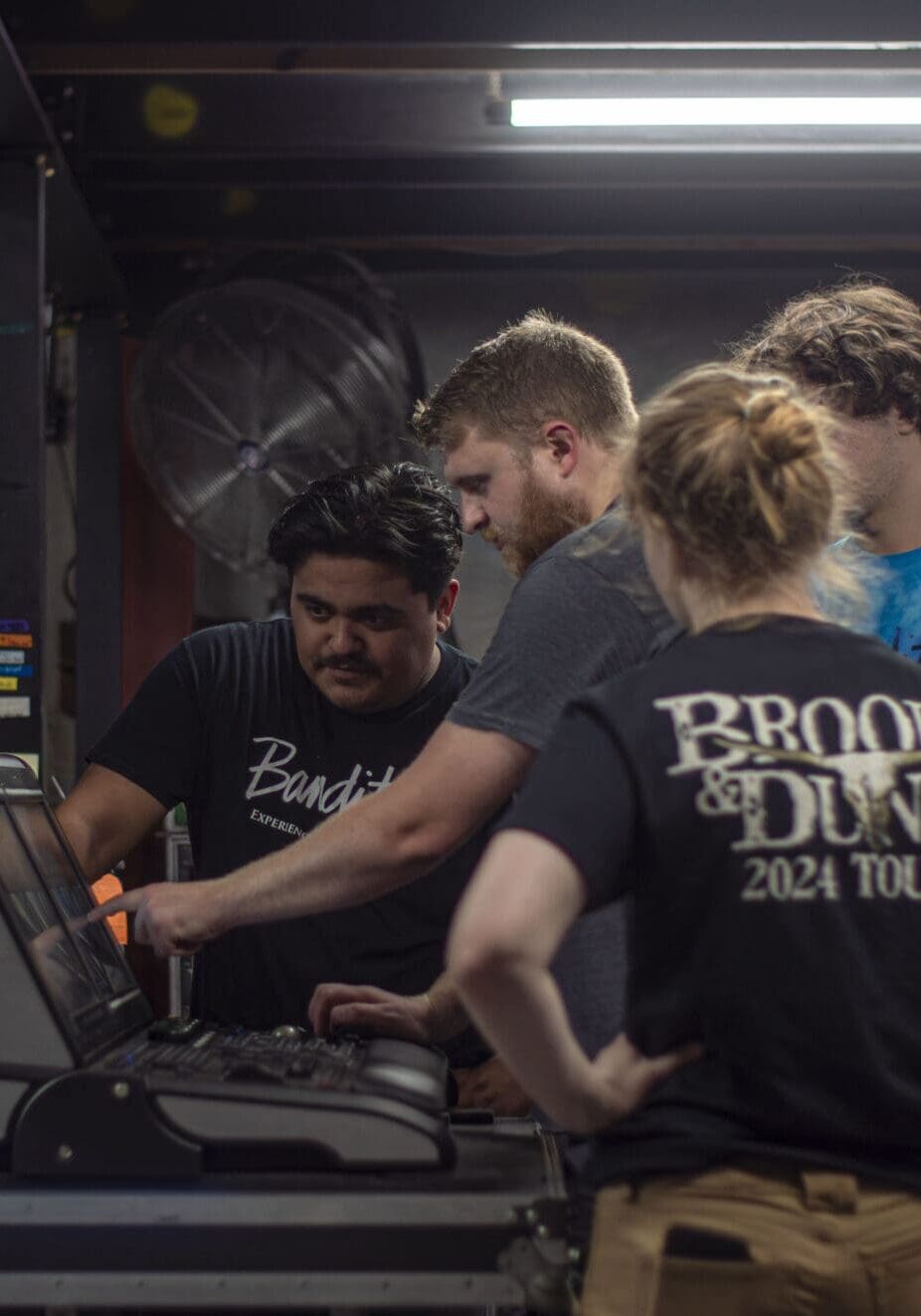A group of young adults working together on a project indoors.