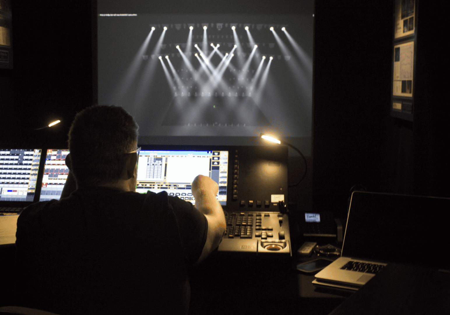Technician managing lighting controls during a live event.