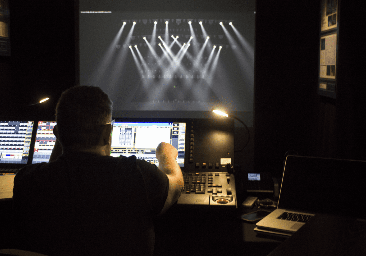 Technician managing lighting controls during a live event.