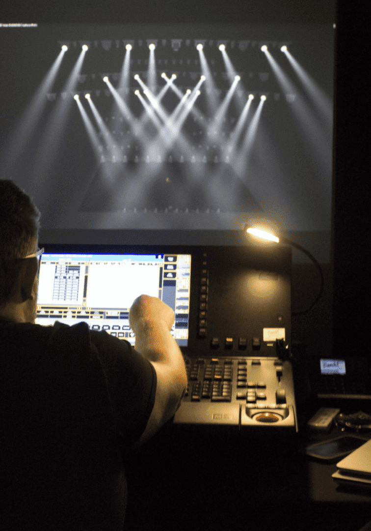 Technician managing lighting controls during a live event.